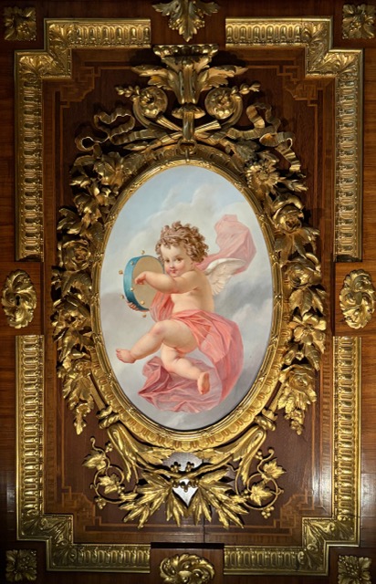 Cherub with tambourine in a golden medallion (19th century) ,  Victoria and Albert Museum, London, United Kingdom