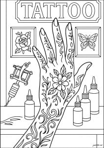 Tattooed hand in a tattoo studio